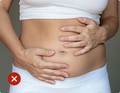 Person holding their stomach with a red 'X' mark over it, indicating discomfort or illness.