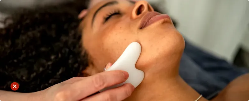 Person using a white device on their neck with a blurred background