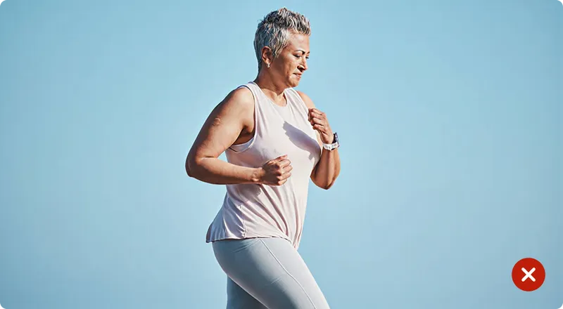 Woman exercising outdoors with a clear blue sky background