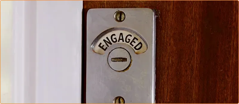 Metallic 'ENGAGED' switch on a wooden door