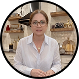 Woman wearing glasses and a white shirt in a kitchen setting