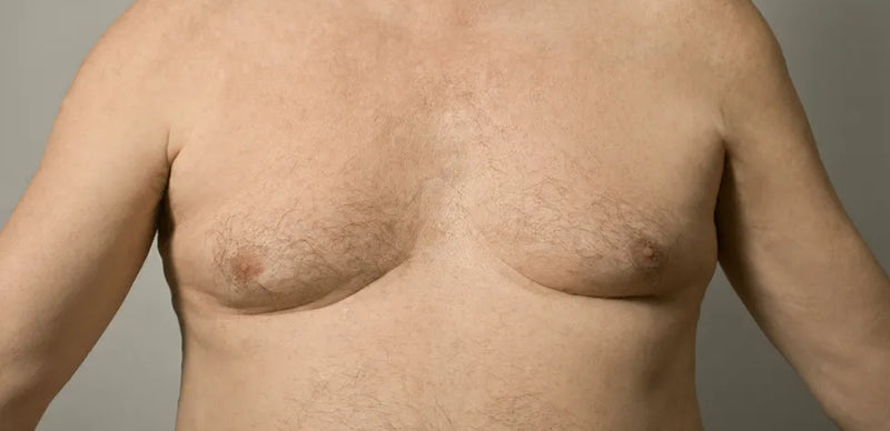 Partial view of a person's torso with a neutral background